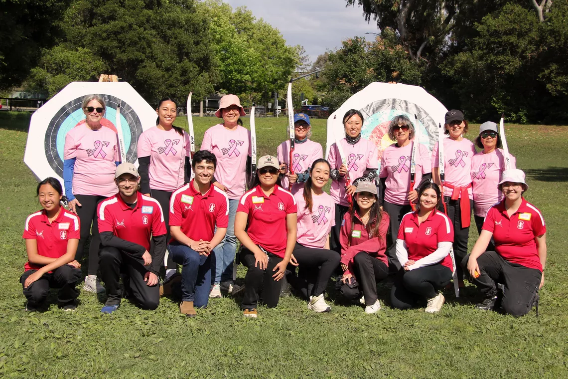 Katherine Wu, Stanford Archery and Archery RX students posing for a photo in front of targets.