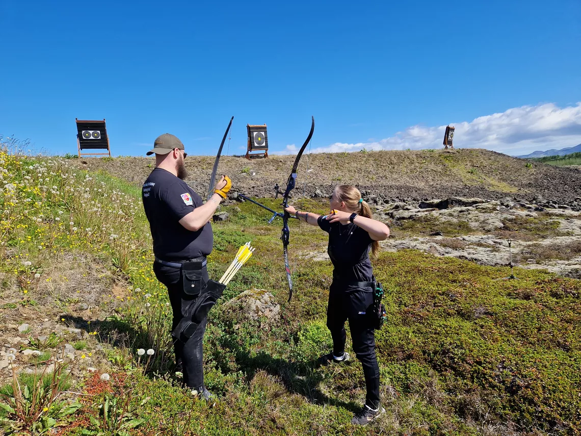 Archers on volcanic landscape in Iceland.