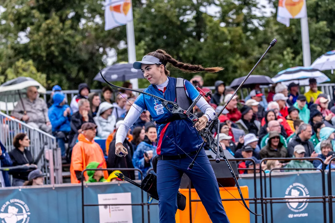 Marie Horackova smiling and walking back to her coach after winning the Berlin 2023 World Championships. 