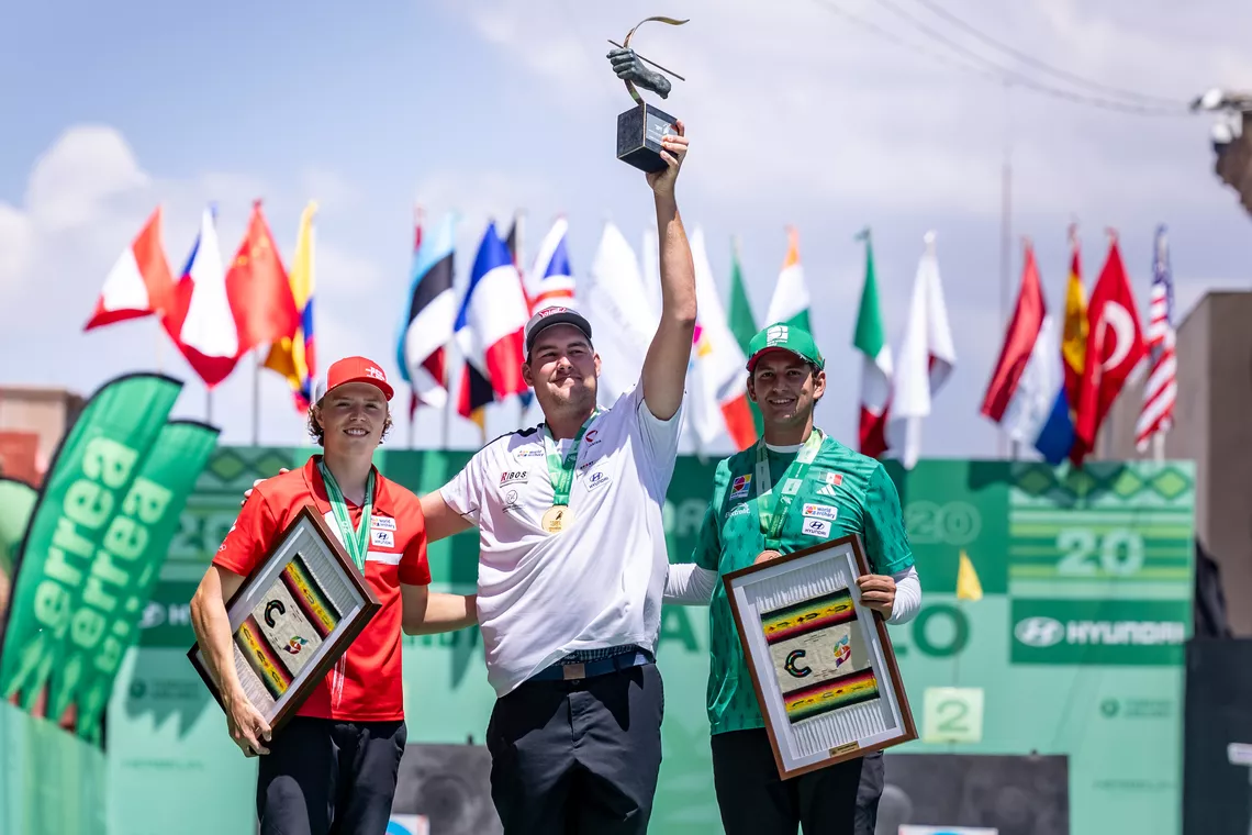 Nico Wiener lifting the Archery World Cup trophy with Mathias Fullerton and Rodrigo Gonzalez de Alba on the podium at Saltillo..
