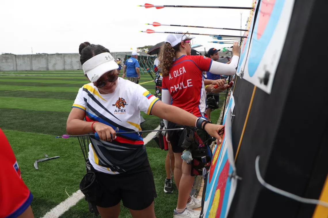 An archer for Apex Archery reviews their target