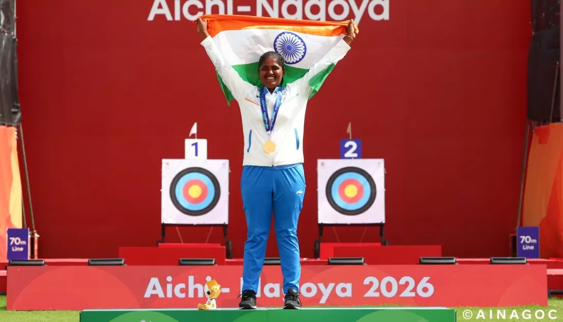 An athlete celebrates on podium