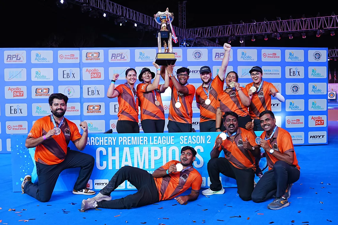 Athletes celebrate with trophy after their victorious campaign 