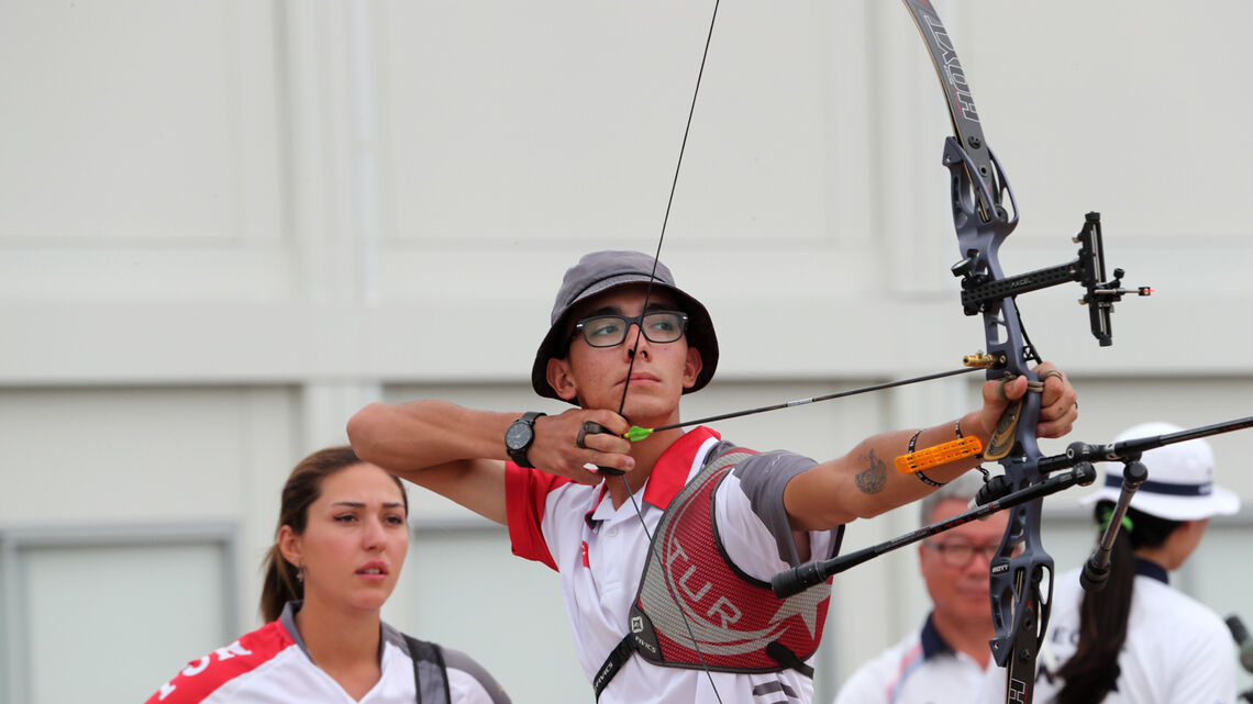 Yasemin Anagoz watches Mete Gazoz shoot at the Tokyo 2020 Test Event.