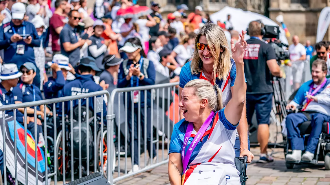 Tereza Brandtlova celebrating W1 mixed team gold with home crowd.