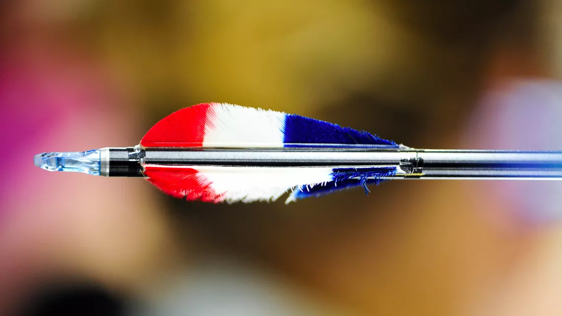 Arrow with feathers and blurred background.