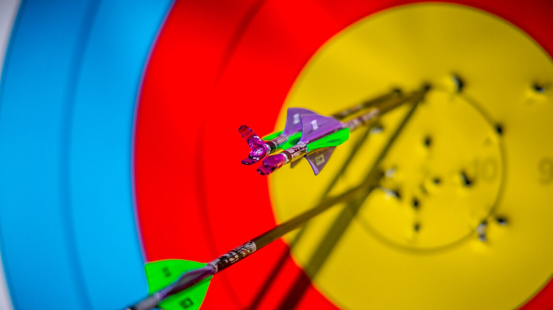 Arrows in a target with broken nock.