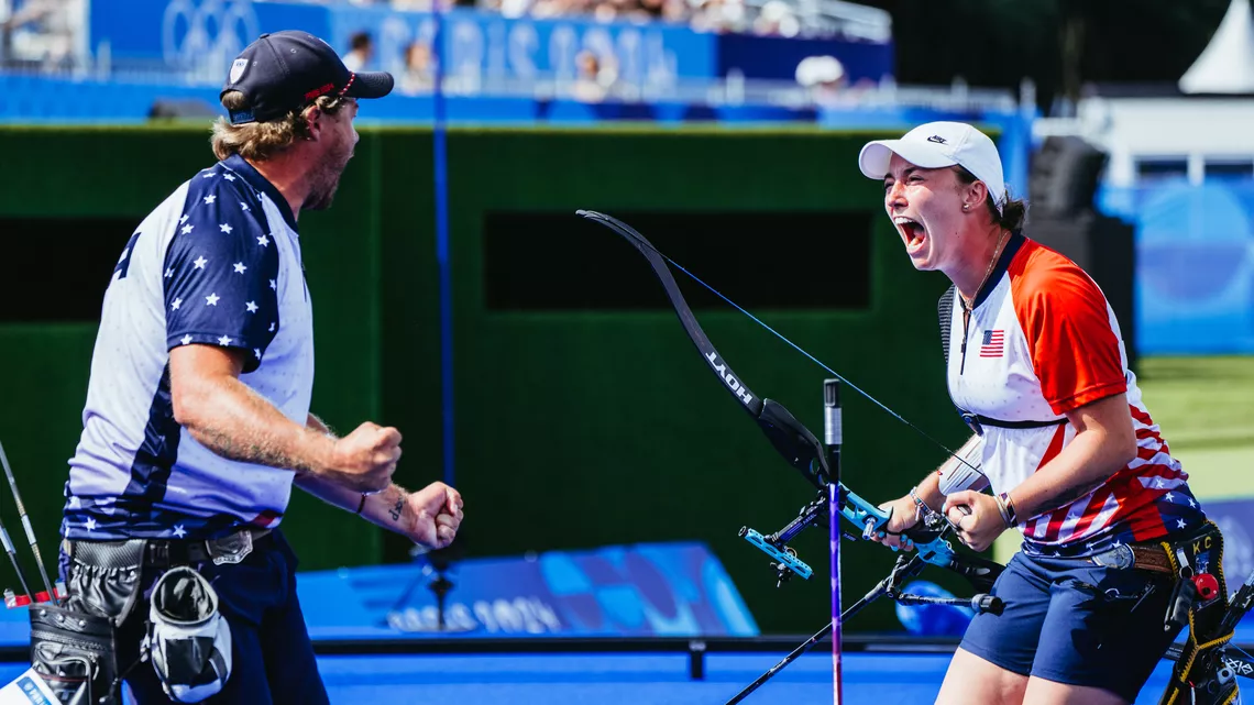 Brady Ellison and Casey Kaufhold celebrating after winning the mixed team bronze