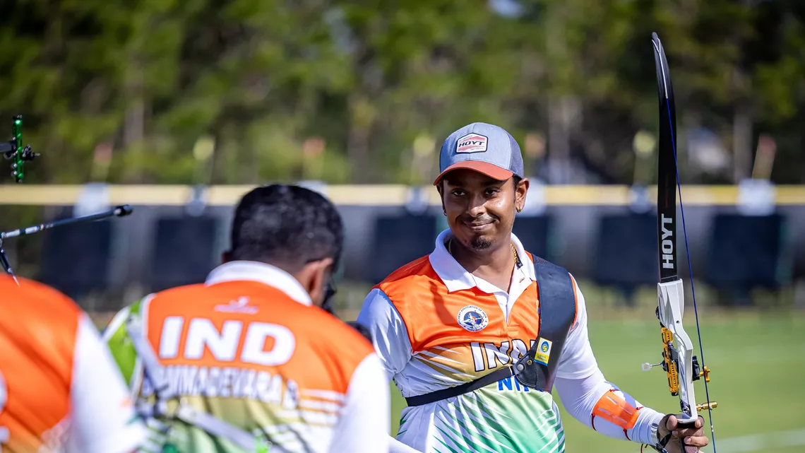 Atanu Das smiling at his teammates.