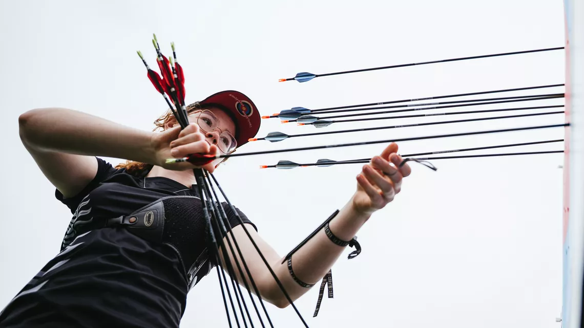 Archer getting arrows from target during unofficial practice at Winnipeg 2025.