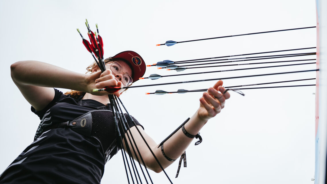 Archer getting arrows from target during unofficial practice at Winnipeg 2025.