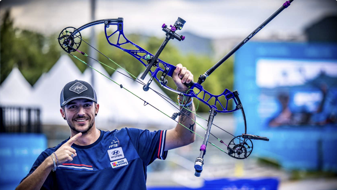 Nicolas Girard pointing to his bow.