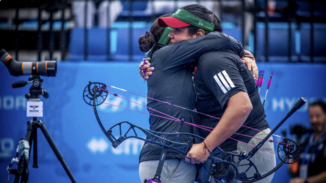 Becerra hugging her coach after winning the World Championships.