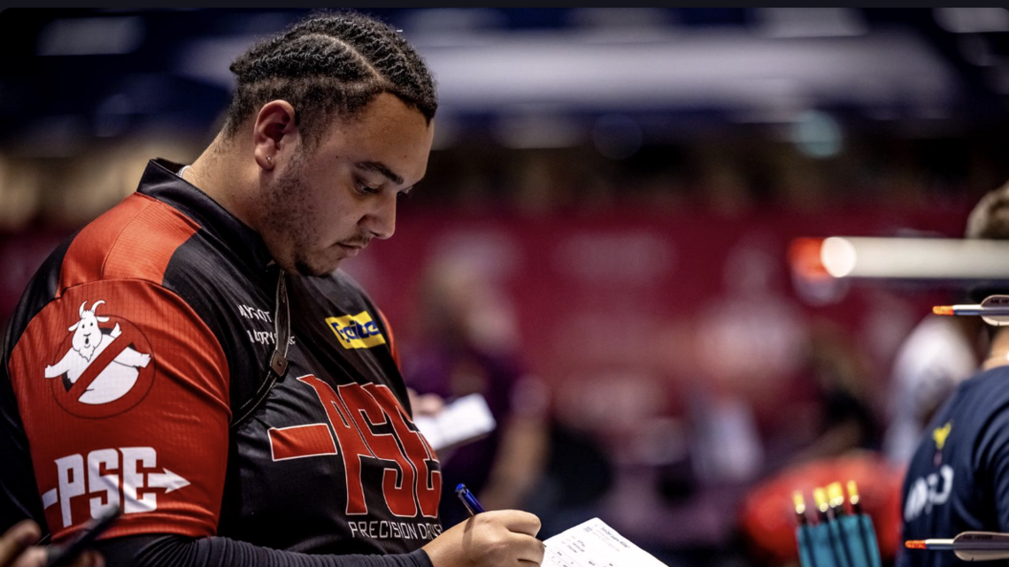 Ajay Scott writing down his scores at Lausanne.