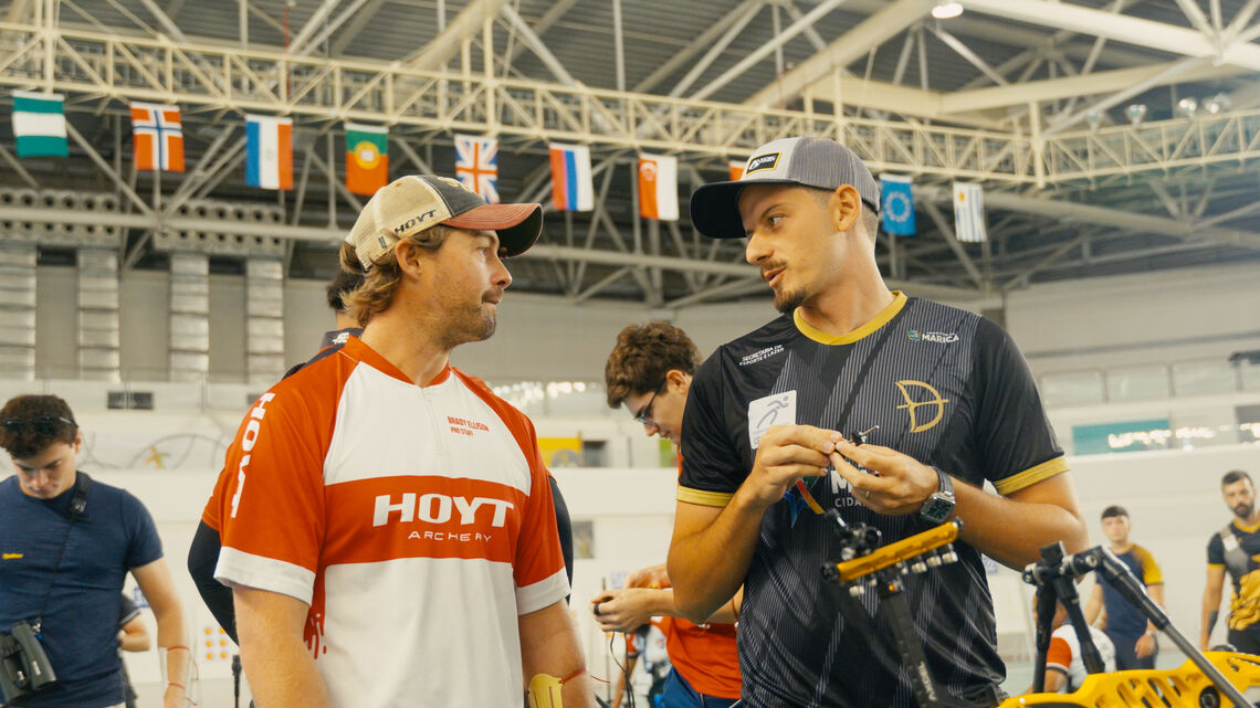 Brady Ellison and Marcus D'Almeida speaking to one another.