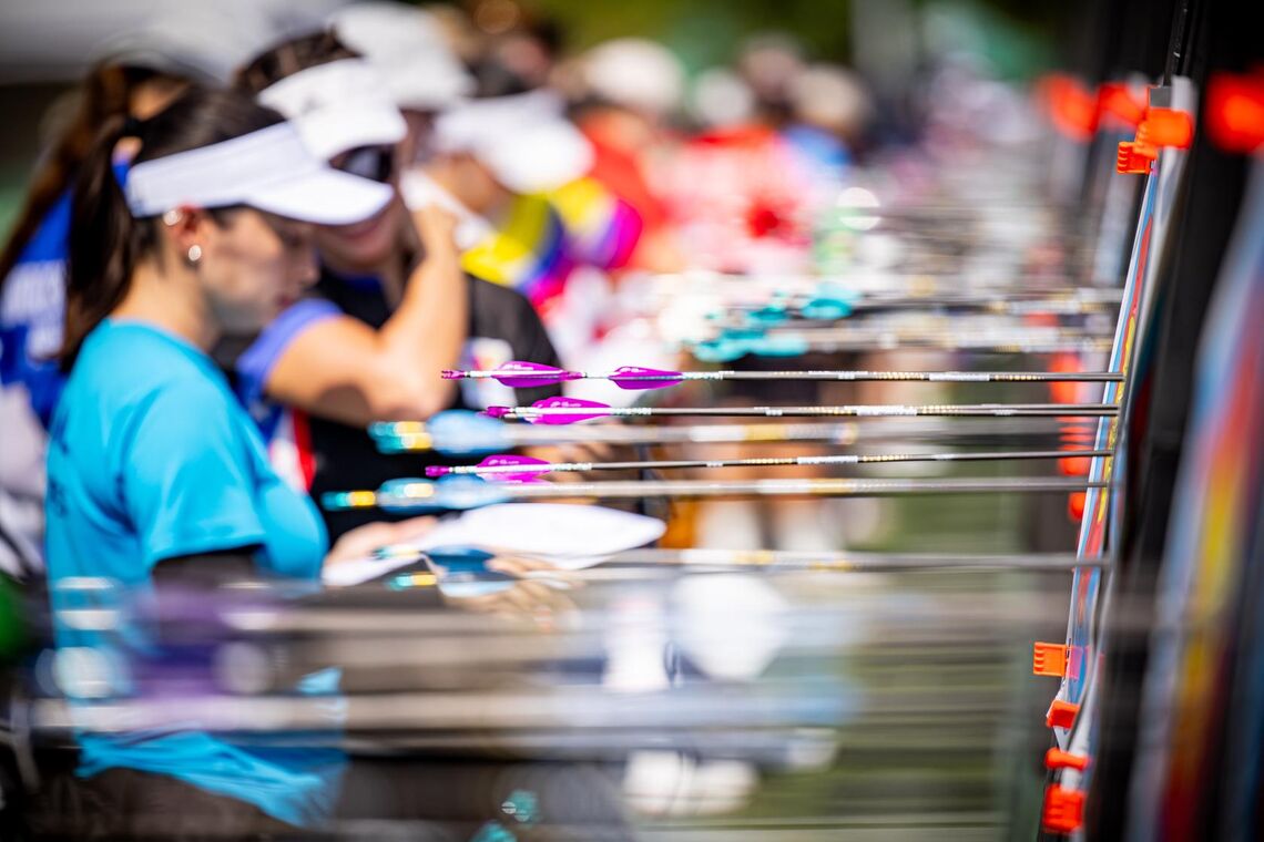 A group of archers looking at where their arrows landed on the targets.