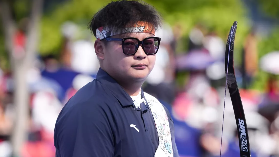 Li Mengqi staring down at the camera during his gold medal match at Shanghai 2026.