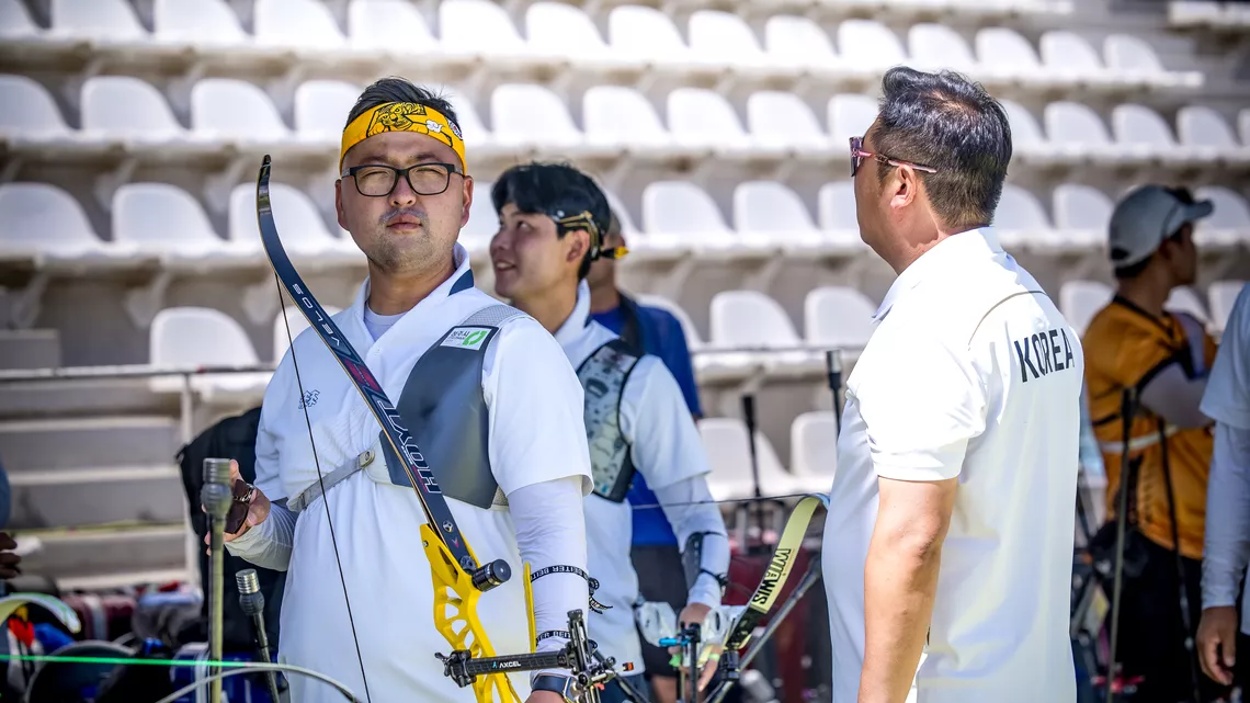 Kim Woojin looking straight down the lens with Lee Woo Seok laughing behind him at Madrid 2026.