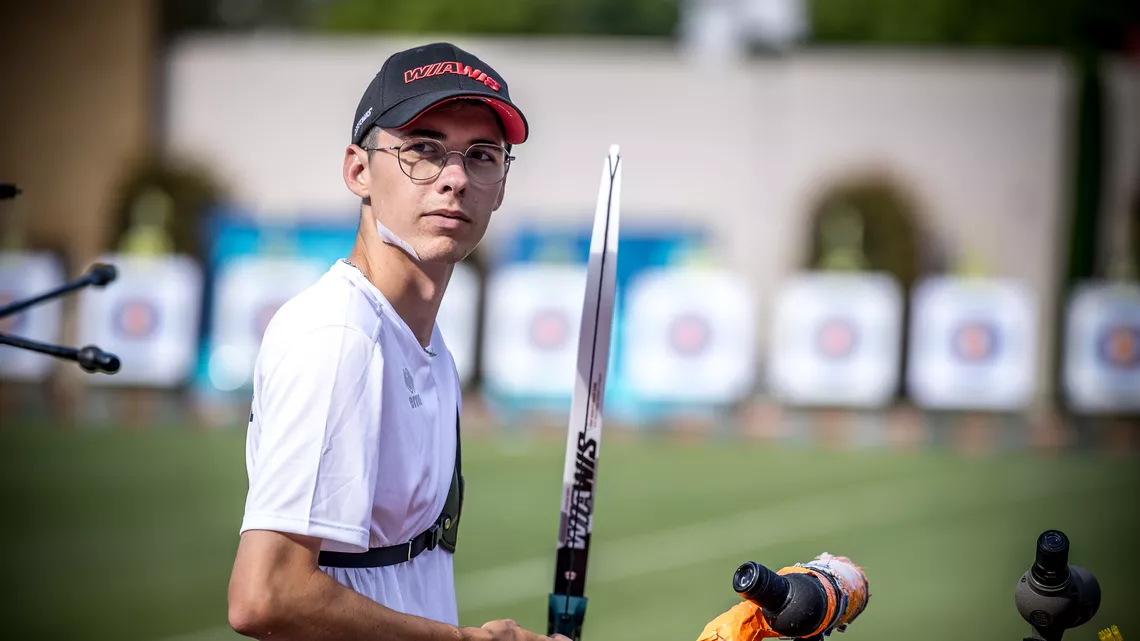 Baptiste Addis looking back at his coach after shooting. 