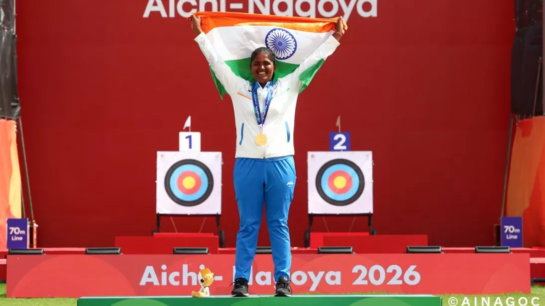 An athlete celebrates on podium