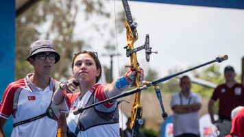 Yasemin Anagoz shoots as Mete Gazoz looks on during the mixed team finals at Antalya 2019.