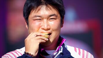 Oh Jin Hyek bites his gold medal at the London 2012 Olympic Games.