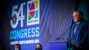 Tom Dielen speaks at the World Archery Congress in 2021.