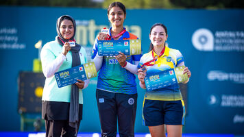 Athletes pose on the podium