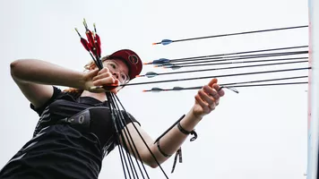 Archer getting arrows from target during unofficial practice at Winnipeg 2025.