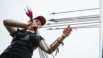 Archer getting arrows from target during unofficial practice at Winnipeg 2025.