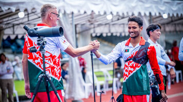 An athlete celebrates a good round with coach.