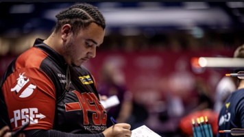 Ajay Scott writing down his scores at Lausanne.