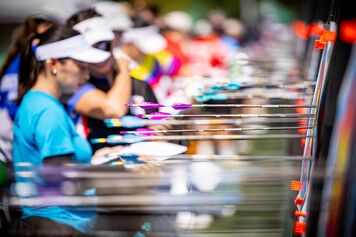 A group of archers looking at where their arrows landed on the targets.
