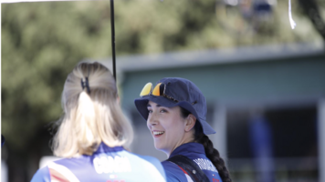 Marie Horackova smiling back at her coach at the 2026 Spring Arrows. 