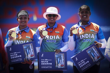 Archers pose on podium