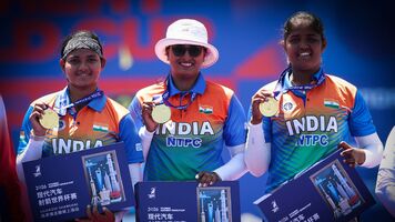 Archers pose on podium