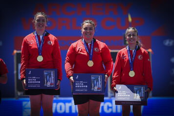 Athletes pose on podium