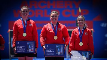 Athletes pose on podium