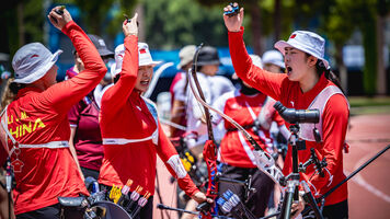 Jiaman, Yuwei and Jingyi with their hands in the air shouting during their semifinal match against Türkiye in the recurve women team event at Antalya 2026.. 