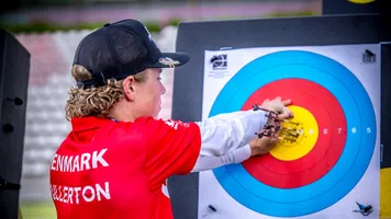 Mathias Fullerton pulling out arrows from the 10-ring at Madrid 2026.