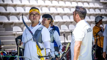 Kim Woojin looking straight down the lens with Lee Woo Seok laughing behind him at Madrid 2026.