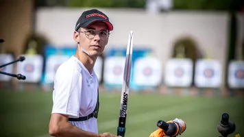 Baptiste Addis looking back at his coach after shooting. 